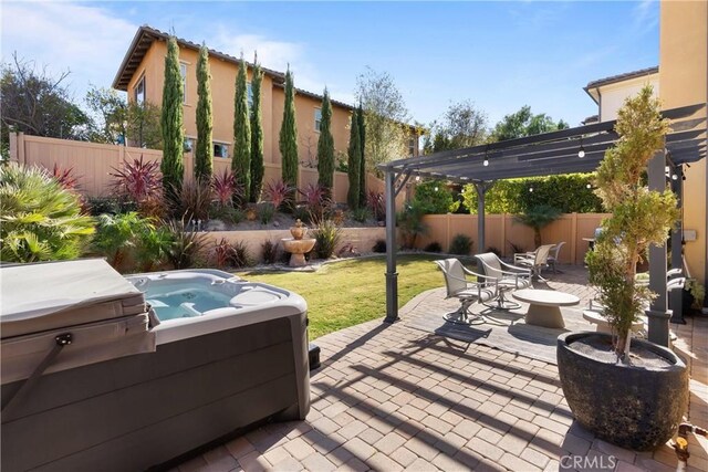 view of patio / terrace with a hot tub and a pergola