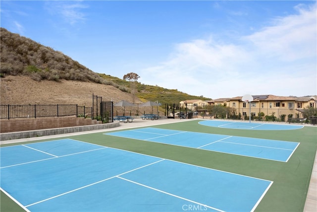 view of sport court featuring fence