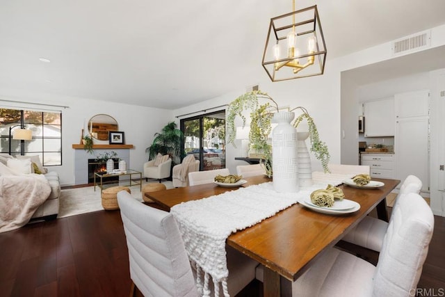 dining area featuring an inviting chandelier and dark hardwood / wood-style flooring