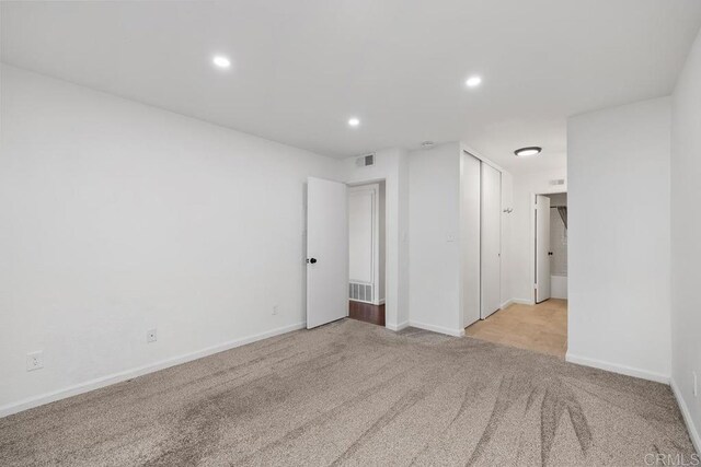 empty room featuring light colored carpet