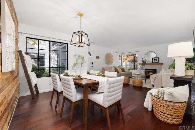 dining room with an inviting chandelier and dark wood-type flooring