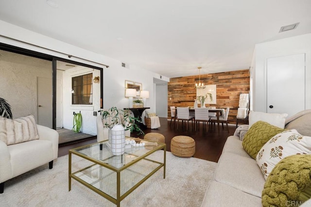 living room with light hardwood / wood-style floors and wood walls