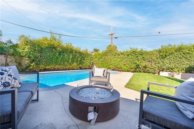 view of pool with a patio and an outdoor fire pit