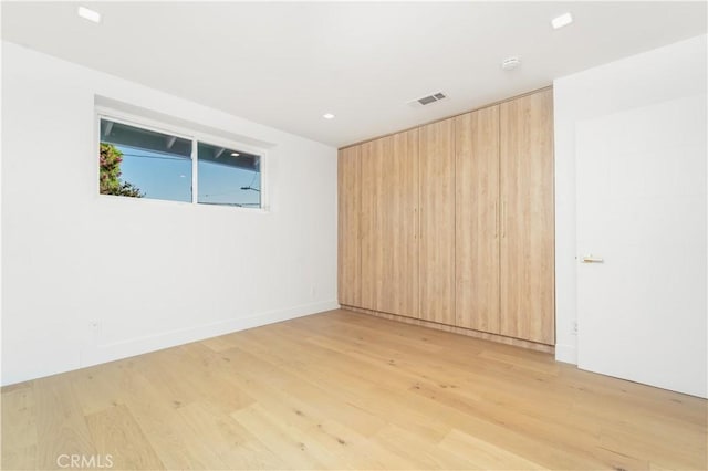 unfurnished room with light wood-type flooring