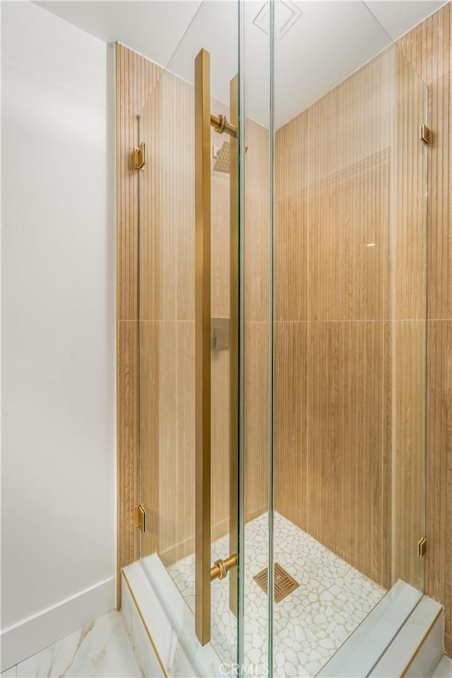 bathroom featuring a shower with shower door