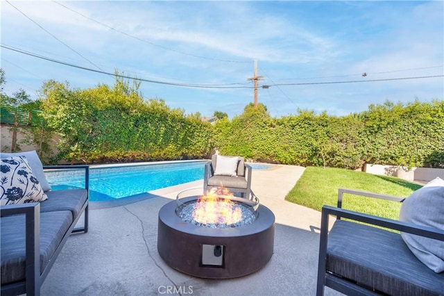 view of pool featuring a patio and an outdoor fire pit