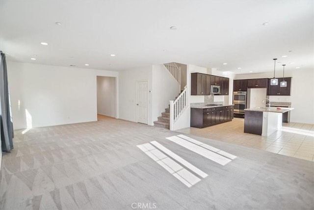 carpeted living room with sink