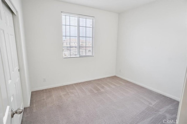 unfurnished room featuring light carpet