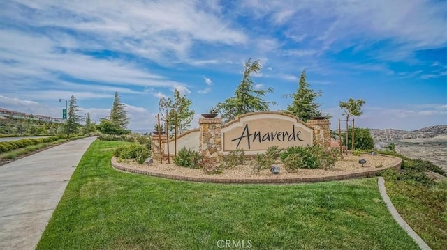 community sign featuring a lawn