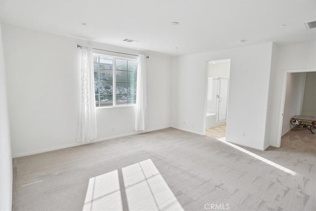 unfurnished room with light colored carpet