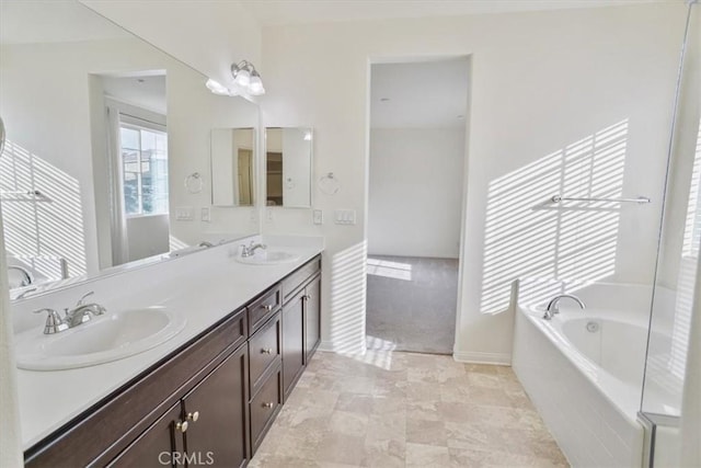 bathroom with vanity and a washtub