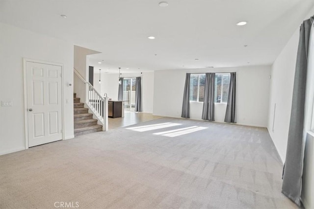 unfurnished living room featuring light carpet