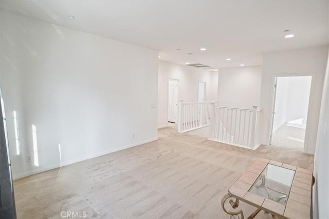 spare room with light colored carpet