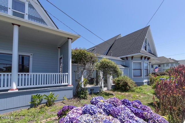 view of property exterior with covered porch