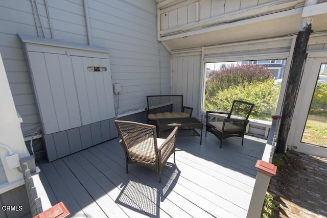 wooden terrace featuring an outdoor living space