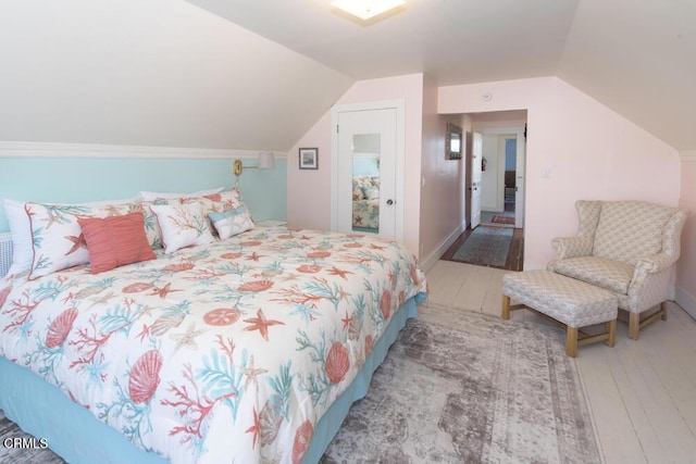 bedroom with lofted ceiling and hardwood / wood-style floors