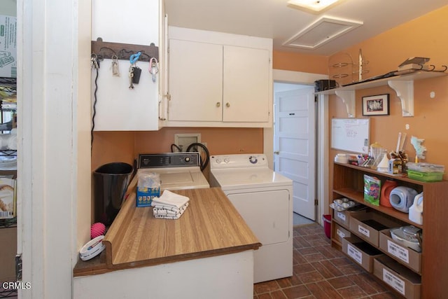 washroom featuring washer and clothes dryer and cabinets