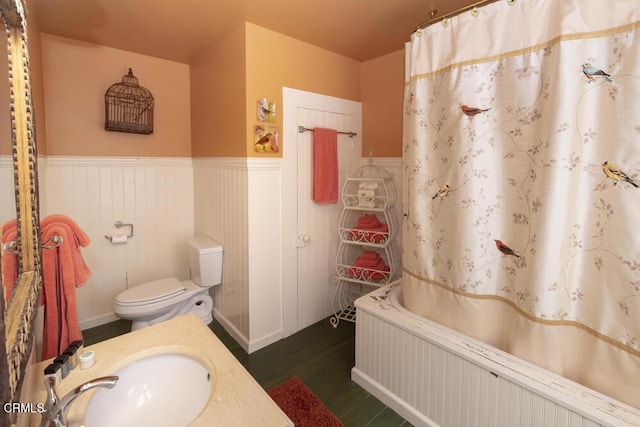 bathroom featuring hardwood / wood-style flooring, vanity, toilet, and curtained shower