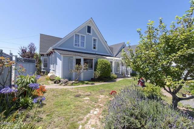 rear view of house with a yard