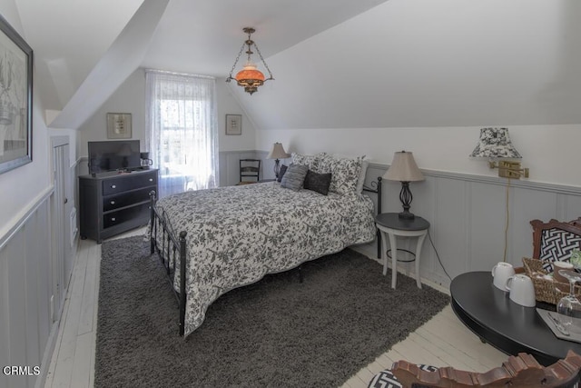 bedroom featuring wood-type flooring and vaulted ceiling