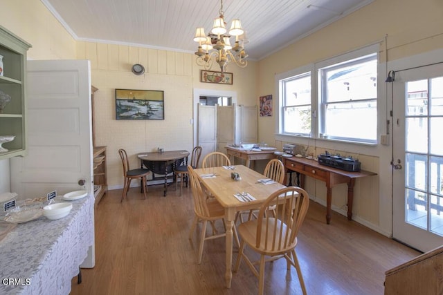 dining space featuring wood ceiling, a notable chandelier, hardwood / wood-style flooring, and ornamental molding