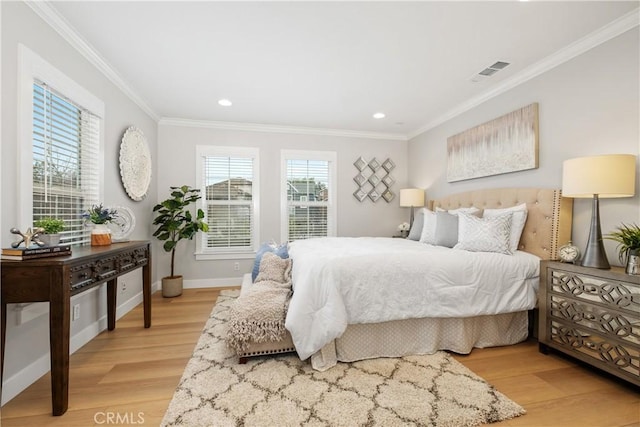 bedroom with multiple windows, ornamental molding, and light wood-type flooring