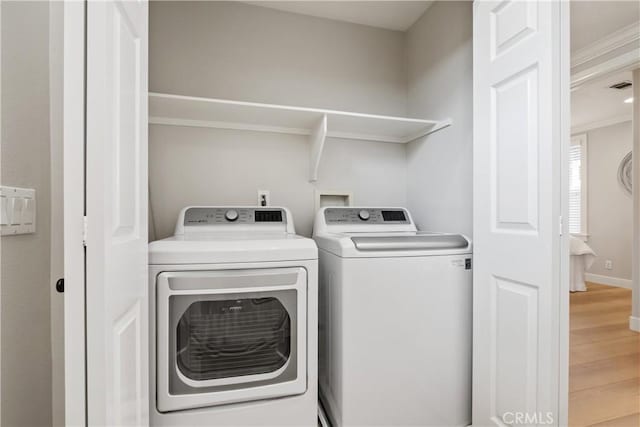 washroom featuring washer and dryer and light hardwood / wood-style flooring