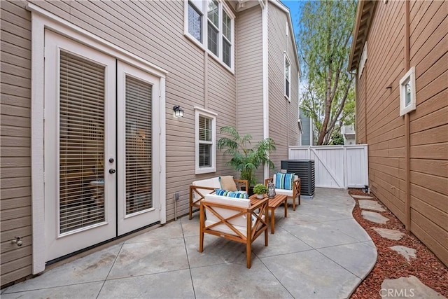 view of patio featuring an outdoor living space, central AC unit, and french doors