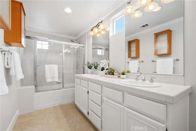 bathroom featuring enclosed tub / shower combo, ornamental molding, and vanity