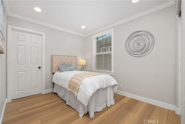 bedroom with crown molding and hardwood / wood-style flooring