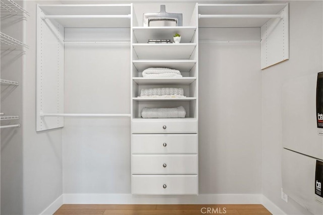 walk in closet featuring hardwood / wood-style flooring