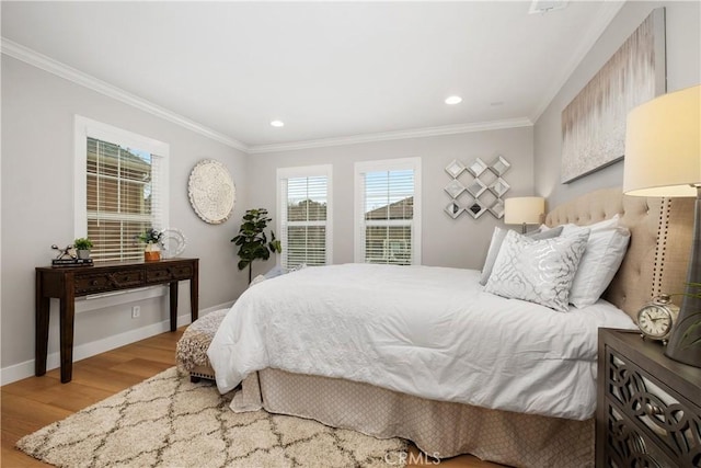 bedroom featuring ornamental molding and light wood-type flooring