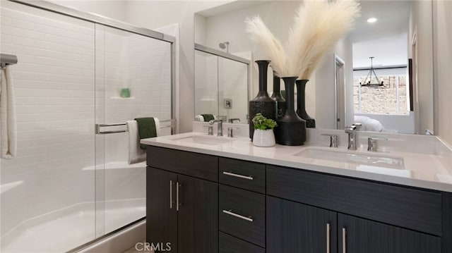 bathroom with vanity and a shower with door