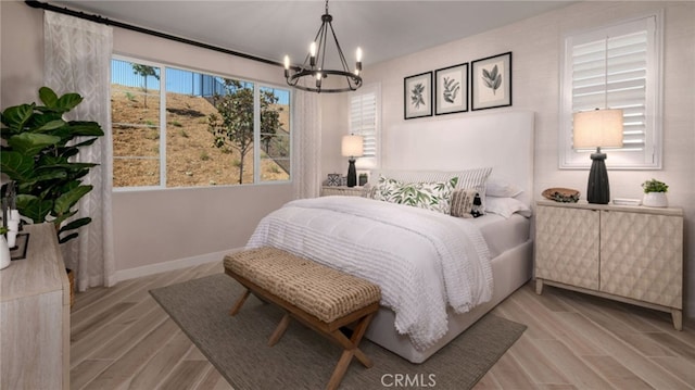 bedroom with a chandelier and light hardwood / wood-style flooring