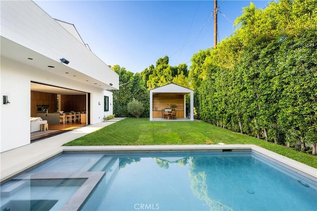 view of swimming pool featuring a lawn and a bar