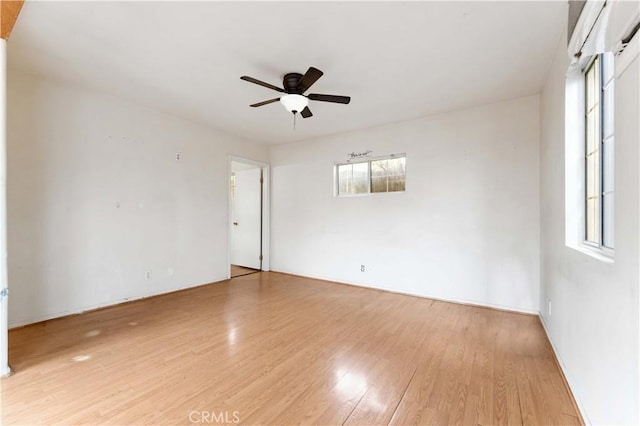 empty room featuring ceiling fan and light hardwood / wood-style floors