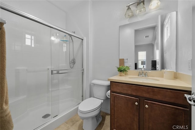 bathroom with visible vents, vanity, a shower stall, and toilet