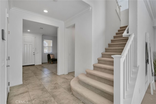 foyer entrance featuring recessed lighting, crown molding, stairway, and baseboards