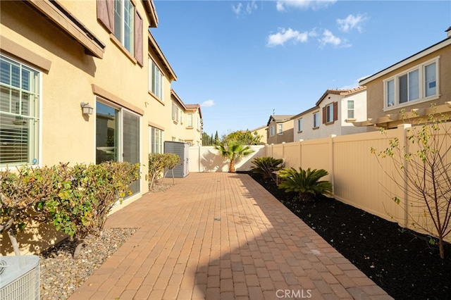 view of patio featuring a fenced backyard and a residential view