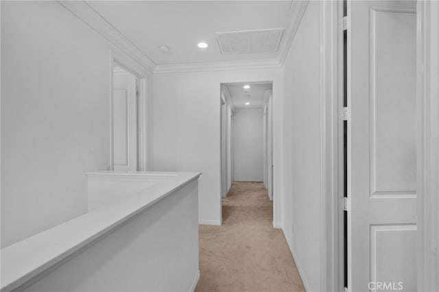 corridor with crown molding, recessed lighting, light colored carpet, visible vents, and baseboards