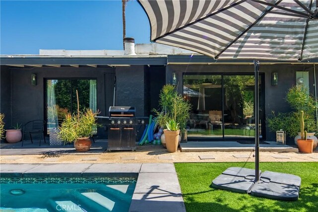 250 W Cortez Rd, Palm Springs, CA 92262 - rear view of house featuring stucco siding, an outdoor pool, and a patio