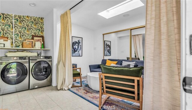 250 W Cortez Rd, Palm Springs, CA 92262 - washroom with wallpapered walls, independent washer and dryer, a skylight, an accent wall, and tile patterned flooring