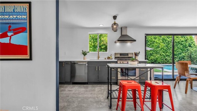 250 W Cortez Rd, Palm Springs, CA 92262 - kitchen with stainless steel appliances, wall chimney range hood, concrete floors, a sink, and light countertops