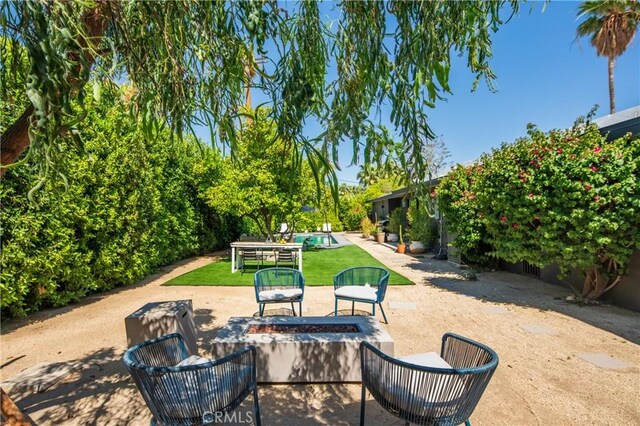 250 W Cortez Rd, Palm Springs, CA 92262 - view of patio / terrace with a fire pit