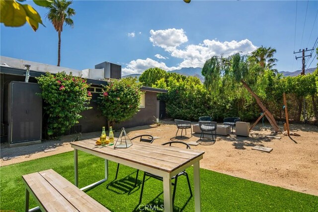250 W Cortez Rd, Palm Springs, CA 92262 - view of green lawn featuring a mountain view, a patio area, and outdoor lounge area