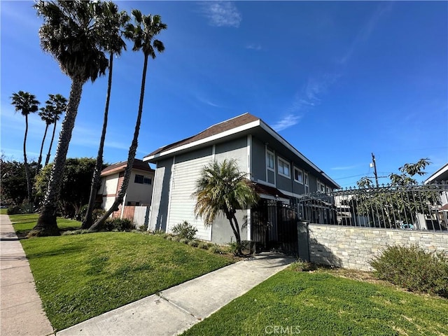 view of side of property with a lawn