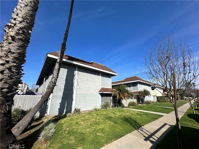 view of property exterior with a lawn