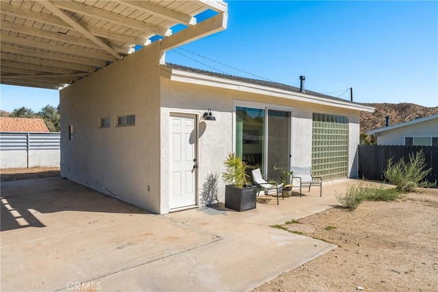 rear view of house with a pergola and a patio area