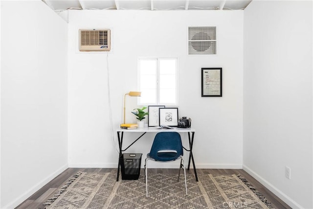 office with hardwood / wood-style flooring and a wall unit AC