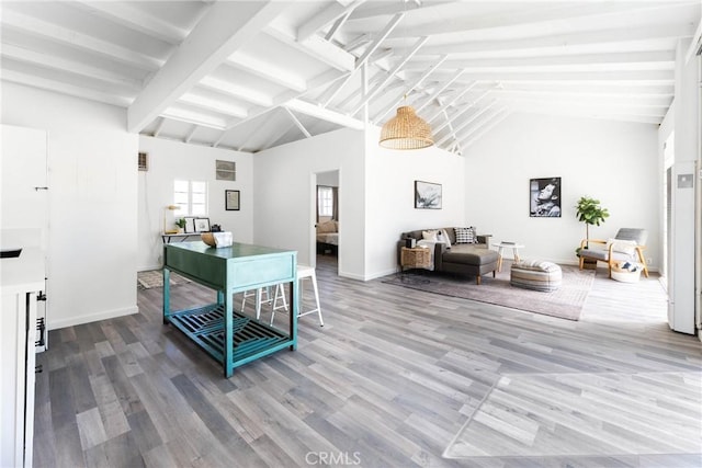 living room featuring hardwood / wood-style floors, beam ceiling, and high vaulted ceiling